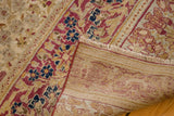 Antique Kermanshah carpet's hand-knotted foundation, fringe, and worn mil fleur pattern.