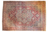 Antique Kerman carpet with concentric star medallion, plum red field, scrolling mil fleur vinery.