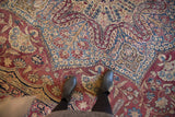 Persian Kerman carpet showcasing mil fleur floral bouquets and scrolling vinery in plum and powder blue.