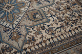 Heriz geometric vinery and border motifs with distressed navy, brown, and ivory.