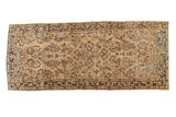 Distressed vintage Persian Sarouk runner, beige field with bursting blue and brown floral motifs.