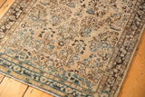 Distressed Sarouk runner border with faded blue floral design and visible foundation wear.