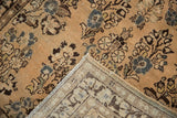 Distressed Sarouk runner corner, highlighting floral pile with faint foundation and hand-knotted back.