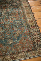 Distressed vintage Hamadan rug showing dusty teal Herati motif and bronze-toned patterned border.