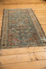 Distressed Hamadan rug features faded dusty teal and bronze Herati motifs, showcasing wear.