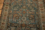 Distressed vintage Hamadan rug's Herati motif with dusty teal and blush tones.