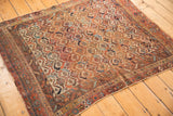 Antique Afshar rug corner with colorful geometric lattice, visible wear, and secured borders.