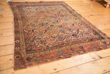 Corner detail of antique Afshar rug, showcasing geometric motifs, madder red border, and softened edge.