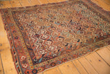Lower right border of antique Persian Afshar rug, with madder root red, sky blue, and aged gold motifs.