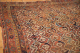 Antique Afshar rug showing geometric lattice patterns in madder red, ivory, and sky blue.