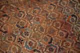 Detailed rectilinear geometric floral pattern on antique Afshar rug, showing wear and varied tones.