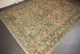 Distressed Hamadan rug, muted ivory and dusty teal floral bouquet, showing softened pile.