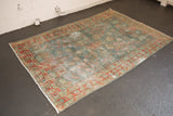 Distressed vintage Hamadan rug with aqua blue floral field and terra cotta border.
