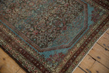 Close-up of a Malayer's brilliant blue spandrel, distressed Herati field, and multi-band border.