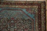 Corner of a distressed Persian Malayer with brilliant blue spandrels and madder red borders.