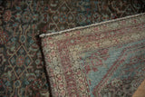 The hand-knotted foundation and secured edge of a vintage distressed Malayer rug.