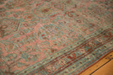 Textured distressed Sarouk rug pile, faded raspberry, blue-green floral motifs, and even wear.