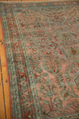 Distressed texture revealing intricate dusty raspberry floral bouquets and ocean blue-green details.
