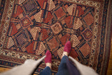 Antique Afshar rug showcasing its striking geometric field in navy, red, and ivory tones.