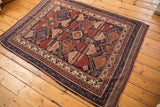 Intricate navy, red, ivory geometric border and secured edge of an antique Afshar rug.