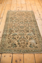 Distressed vintage Sarouk runner with ivory and ocean blue green floral sprays and visible worn areas.