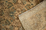 Distressed American Sarouk rug with worn floral pile and tightly hand-knotted foundation.