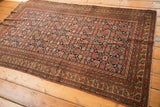 Antique Malayer rug corner, featuring secure fringe, intricate Herati motif, and patterned border.