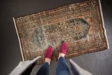 Geometric motifs and aged texture on a distressed vintage Hamadan rug.