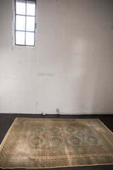 Textured wear on this Vintage Distressed Jaldar rug's grey-blue medallions and multi-banded borders.