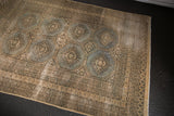 Worn distressed Jaldar rug showing muted blue-grey medallions, visible foundation, and intricate beige borders.