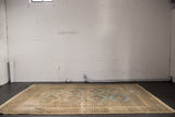 Distressed Jaldar rug featuring repeating slate blue and ivory medallions within intricate borders.