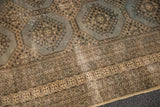 Multi-banded border and octagonal medallions of a distressed Jaldar rug, with visible foundation.