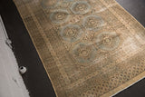 Vintage Distressed Jaldar rug: slate blue medallions, beige field, multi-banded borders, decorative wear.