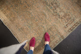 Textured distressed Northwest Persian rug with faded sand, ivory, and powder blue floral design.