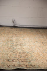 Vintage distressed Northwest Persian rug, faded sand, blue-green floral blossoms with mostly even wear.