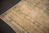Distressed Northwest Persian rug edge with mostly even wear, sandy blue tones, and secure fringe.