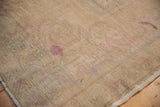Distressed Oushak rug pile texture with worn knot heads and visible foundation.