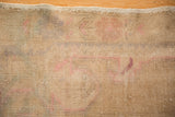 Intact original side selvage of distressed Oushak rug, showing worn ivory and blush pile.
