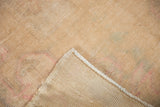 Woven backing and original side cord selvage of the distressed Oushak rug, revealing the worn pile.