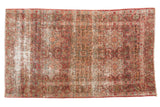 Vintage Persian Meshed rug: cochineal red starburst medallions, milfleur field, visible wear, 4'5