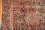 Worn cochineal red, antique ivory, and sky blue starburst medallion detail on vintage Meshed rug.
