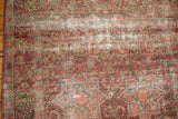 Cochineal red starburst medallions, milfleur field, and visible foundation wear on Meshed rug.