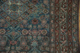 Distressed vintage Malayer rug, Herati motif field, muted teal and rust floral border.