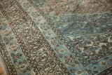 Traditional Bibikabad carpet's worn pile texture, with ocean blue, ivory, and brown Herati motifs.