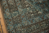 Detail of distressed Bibikabad rug with faded ocean blue Herati motif and visible foundation.