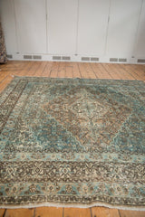 Distressed powder blue, ivory, and brown Herati motifs with noticeable foundation wear.