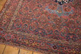 Vintage Bijar rug corner, highlighting intricate Herati and laurel motifs with madder red and navy pile.