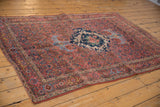 Vintage Bijar rug's madder red field and Herati-like border with faint foundation showing through.