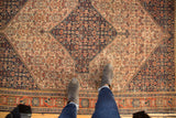Intricate Herati motif on antique ivory field, blending madder red and navy colors.