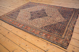 Antique Senneh rug showcasing intricate Herati motif, diamond medallion, madder red, ivory, navy.